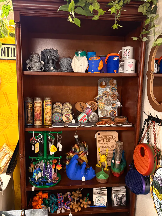 Colorful pottery and small collectibles displayed on store shelves.