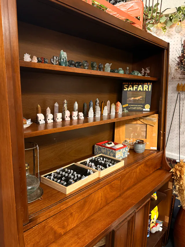 Crystals and small collectible pieces arranged inside a glass cabinet.