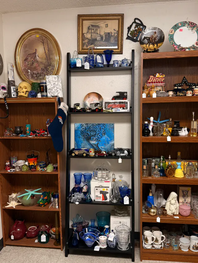 Eclectic shelves filled with vintage decor and collectibles inside Unique Treasures.